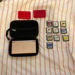DS console and games,case for ds,and two cases for games